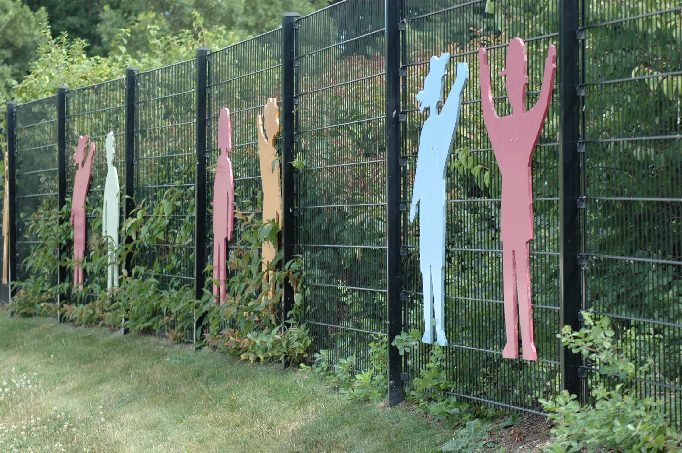 wire steel fence system with attached childrens statue