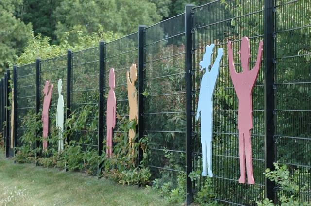 wire steel fence system with attached childrens statue